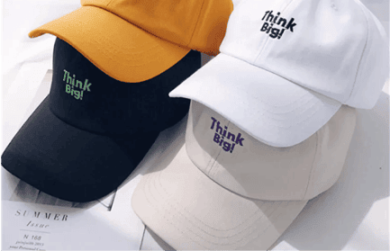 Custom embroidered hats in various colors and stitch colors. The hats feature intricate embroidery on the front panels, showcasing text in black and green color. The embroidery adds a personalized touch to the hats, making them stylish accessories for any outfit."